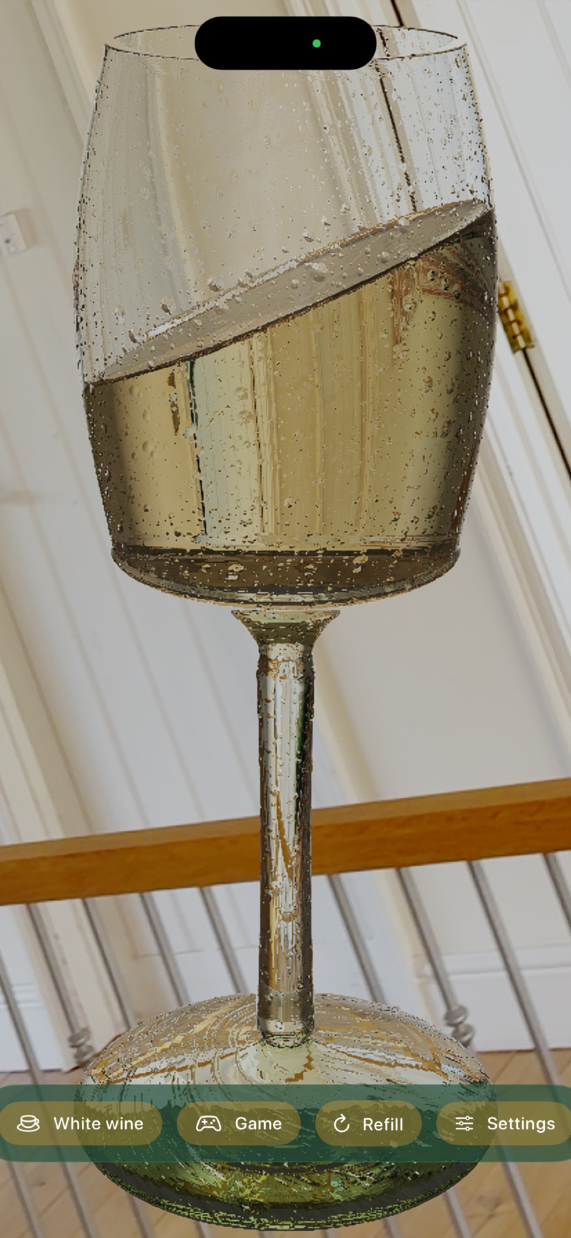 A stemmed white wine glass, tilted to drink, in front of a panelled door
